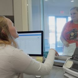 Care Net Medical Services - Although appointments are preferred, we also accept walk-ins! This is a picture of a client speaking with our receptionist.