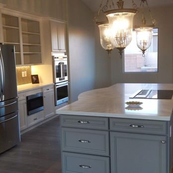 Kitchen Encounters - a kitchen with a center island and stainless steel appliances - Countertop Installation Near Me - Mesquite, Nevada