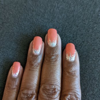 Cali Nails - This is last week's design. Again, a trust option not my choice I LOVE IT! - A hand with dark skin displays nails painted in peach with silver glitter accents at the tips, resting on a dark fabric surface. - Nail Salons Near Me - Phoenix, Arizona