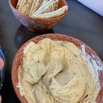 Mosaic Grill - HUMMUS - Hummus topped with olive oil and served with flat pita wedges. - Mediterranean Near Me - Belton, Texas Mosaic Grill - HUMMUS - Hummus topped with olive oil and served with flat pita wedges. - Mediterranean Near Me - Belton, Texas