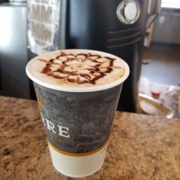 a cappuccino in a paper cup a cappuccino in a paper cup