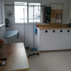 Salmon Harbor Rv Park - Laundry Room has a change machine and a dispenser for detergent and fabric softener.
