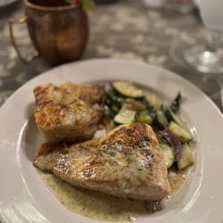 Miss Hattie's Restaurant and Cathouse Lounge - Salmon, prepared with a garlic butter sauce, scalloped potatoes, and the vegetable medley
