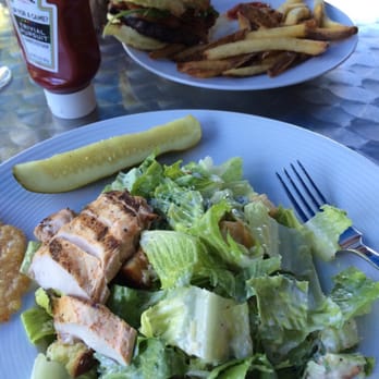 Bear Mountain Inn - Caesar salad with juicy chicken and delicious burger in the background - Hotels Near Me - Bear Mountain, New York Bear Mountain Inn - Caesar salad with juicy chicken and delicious burger in the background - Hotels Near Me - Bear Mountain, New York