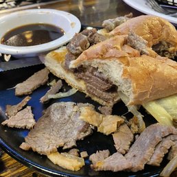 French dip cut in half, showing the streakums quality meat. French dip cut in half, showing the streakums quality meat.