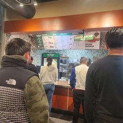Wingstop - People in line all waiting for their orders.