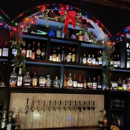 a bar filled with bottles of alcohol a bar filled with bottles of alcohol