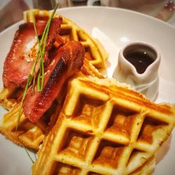 Tea Jenny's - American style waffles with maple syrup and bacon .