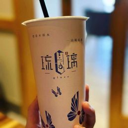 a hand holding a cup of tea a hand holding a cup of tea