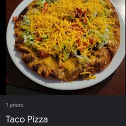 Taco House - Enjoy this delicious Taco pizza it has beans,meat,lettuce, tomatoes, onions, layers of cheese.