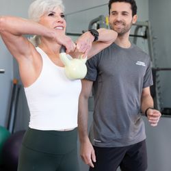 Fitness Together - Female client working with male personal trainer