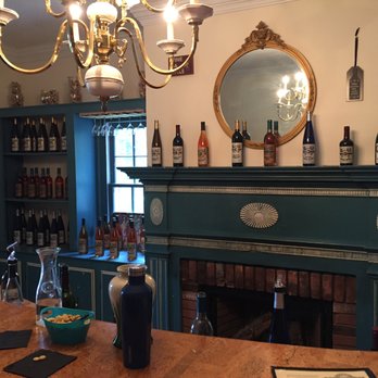 Rogers Ford Farm Winery - a bar with wine bottles and a fireplace - Wineries Near Me - Sumerduck, Virginia
