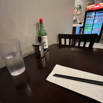 Splendid Noodle - a glass of water and a bottle on a table - Noodles Near Me - Stony Brook, New York