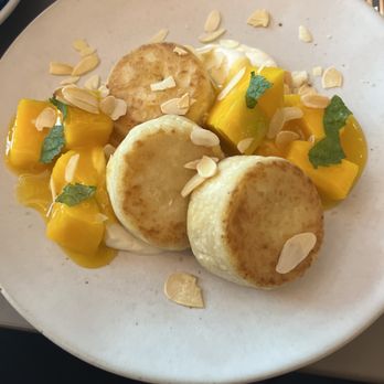 The Folks - Syrniki - Eastern European cottage cheese pancakes with mascarpone cream, mango, and roasted almonds. - Breakfast & Brunch Near Me - Lisbon, 11 The Folks - Syrniki - Eastern European cottage cheese pancakes with mascarpone cream, mango, and roasted almonds. - Breakfast & Brunch Near Me - Lisbon, 11