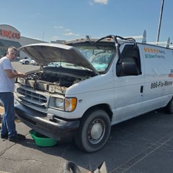 Josh performing a radiator change out in the parking lot of Big Lots in Huntington.