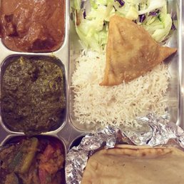 Thali with (clockwise from top right) salad, samosa, rice, naan, braised eggplant/veggies, saag paneer, lamb. Thali with (clockwise from top right) salad, samosa, rice, naan, braised eggplant/veggies, saag paneer, lamb.