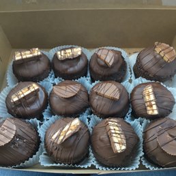 Double dipped Chocolate cupcakes topped with snickers and Reese's