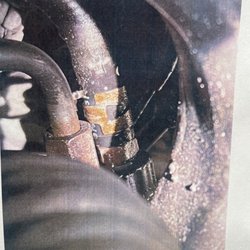 Repair Masters Automotive - Crack in the power steering fluid return hose.