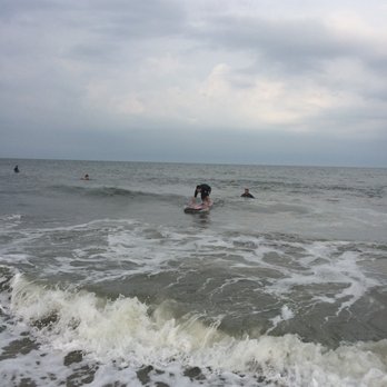 Wave Riding School - In the process of standing up - Surfing Near Me - Ocean City, Maryland Wave Riding School - In the process of standing up - Surfing Near Me - Ocean City, Maryland