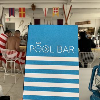 The Pool Bar - Menu and the bar in background. Kitchen window in the far right - Airport Lounges Near Me - Jamaica, New York
