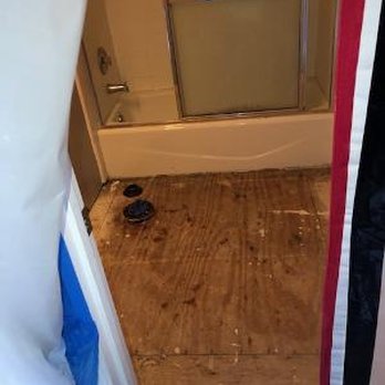 CEO Restoration - This is the view of the bathroom from the hallway. No tile, no toilet, no vanity - Damage Restoration Near Me - Apopka, Florida