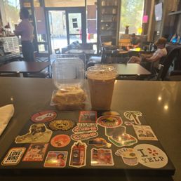 Work counter with iced latte and cinnamon bun