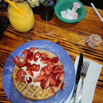 Josie's - Waffle with fresh strawberries, whipped cream and butter with a mimosa - American Near Me - Lexington, Kentucky Josie's - Waffle with fresh strawberries, whipped cream and butter with a mimosa - American Near Me - Lexington, Kentucky