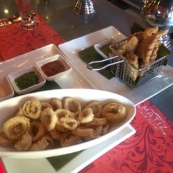 Matiz Latin Cuisine - Calamari (perfectly cooked, flavorful with no hint of rubberiness) and empanadas photobombing in the background - also Yummy.