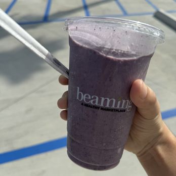 Beaming - hand holding a purple smoothie - Juice Bars & Smoothies Near Me - Long Beach, California Beaming - hand holding a purple smoothie - Juice Bars & Smoothies Near Me - Long Beach, California