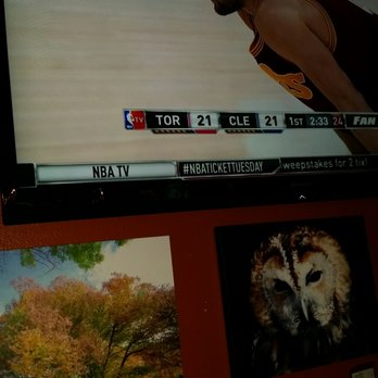 Our Place - One of the TVs right by our table with artwork for sale under it. - New American Near Me - Lake Forest, California Our Place - One of the TVs right by our table with artwork for sale under it. - New American Near Me - Lake Forest, California