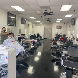 Eugene, the owner busy with a client while another barber sits idle for over twenty minutes for "an appointment". Others are intimidators Eugene, the owner busy with a client while another barber sits idle for over twenty minutes for "an appointment". Others are intimidators
