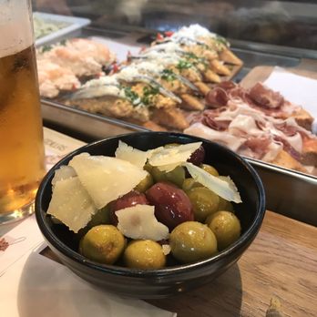 Tapa Tapa - Assorted olives with cheese shavings - Tapas Bars Near Me - Madrid, M Tapa Tapa - Assorted olives with cheese shavings - Tapas Bars Near Me - Madrid, M