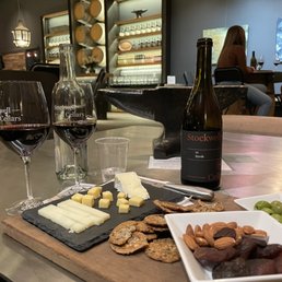 a table with wine, cheese and crackers a table with wine, cheese and crackers
