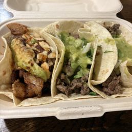 Pork belly taco on the left, carne asada two on the right.