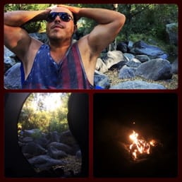 a man in a tank top and a campfire a man in a tank top and a campfire