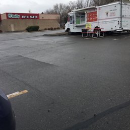 a food truck parked in a parking lot a food truck parked in a parking lot