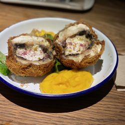 Entre Santos - Stuffed portobello mushrooms with goat cheese and crusted with coconut with a mango purée