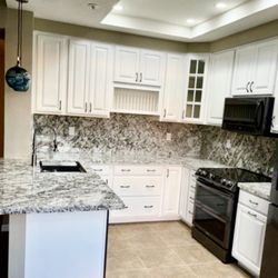 Butler Painting and Construction - New light features, cabinets flooring and paint. Another happy client!