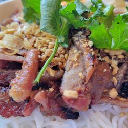Close up of the pork vermicelli ball with egg rolls.