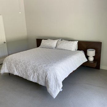 Epoxy It - a bedroom with a bed and nightstand - Flooring Near Me Epoxy It - a bedroom with a bed and nightstand - Flooring Near Me