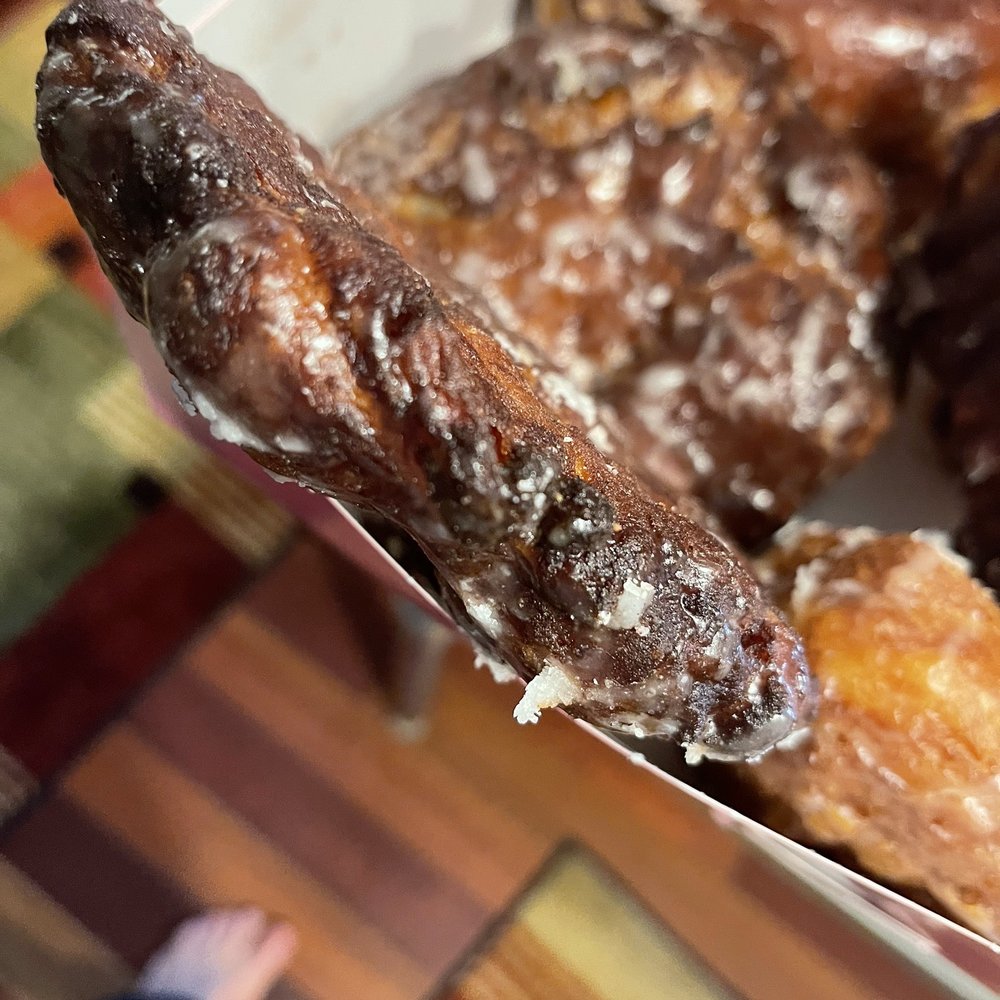 OMG Donuts - a hand holding a donut - Donuts Near Me - Arvada, Colorado OMG Donuts - a hand holding a donut - Donuts Near Me - Arvada, Colorado