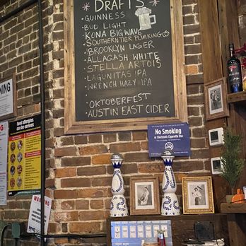 Plug Uglies - a brick wall with a menu on it - Sports Bars Near Me - New York, New York Plug Uglies - a brick wall with a menu on it - Sports Bars Near Me - New York, New York