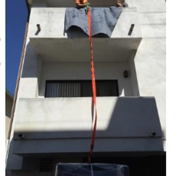 Peter's Moving Services - Successfully lowering a couch, which is all wrapped up to prevent scuffs. - Movers Near Me Peter's Moving Services - Successfully lowering a couch, which is all wrapped up to prevent scuffs. - Movers Near Me