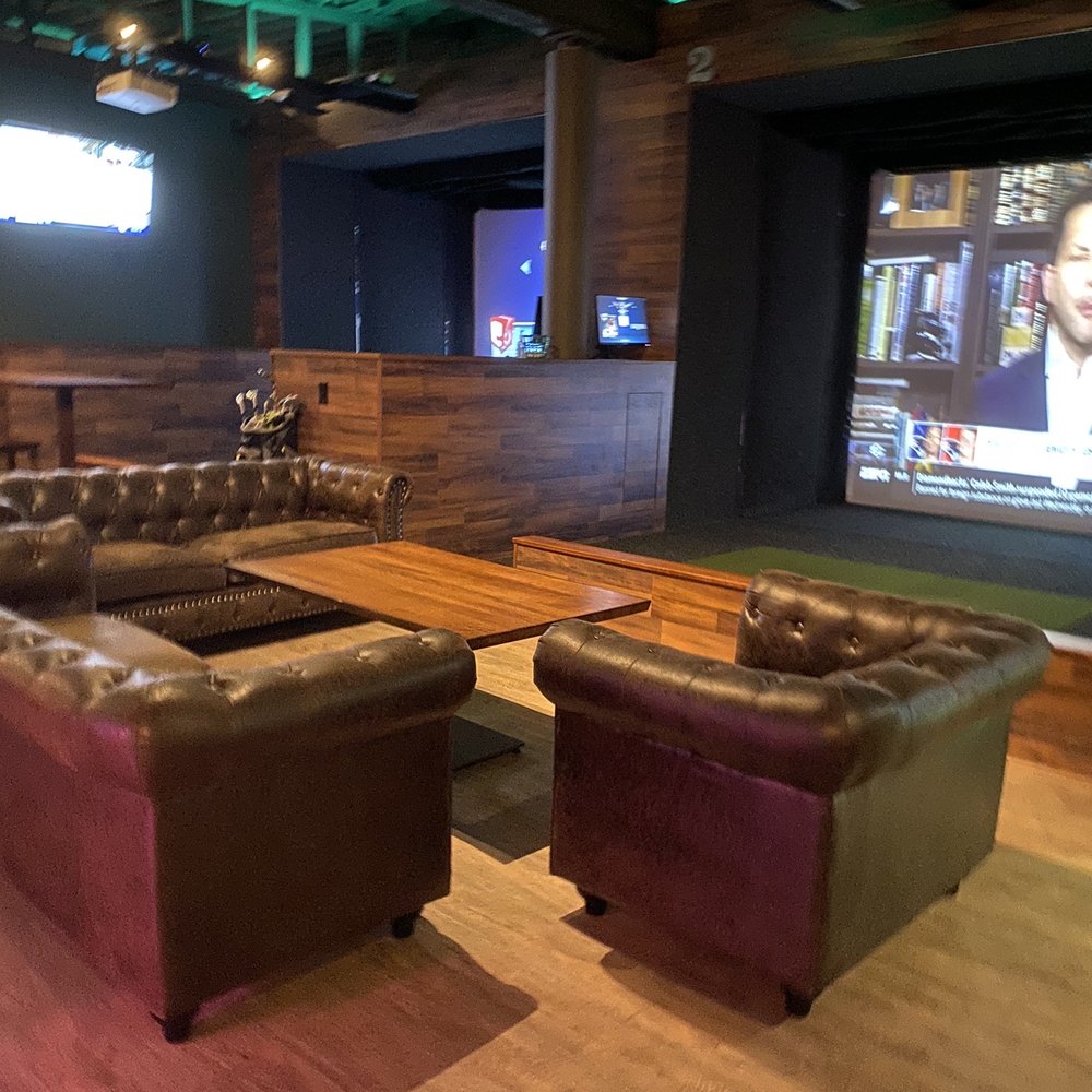 7 Iron Social - a large room with leather couches - Sports Bars Near Me - Madison, Wisconsin