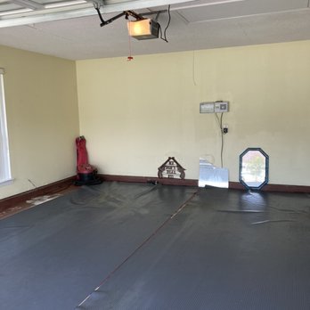 Stratified Solutions - an empty garage with a blue floor - Handyman Near Me - Pensacola, Florida