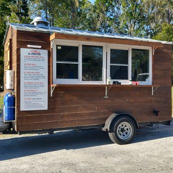 & Lobster - Front of the truck with the menu board. The prices are market so they change based on season. - Food Trucks Near Me