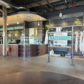 CoffeeDrunk - inside - The image shows the interior of a coffee shop with a counter, display shelves with products, and an industrial-style ceiling with exposed ducts and pipes. - Coffee & Tea Near Me - Phoenix, Arizona