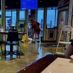 Wings - [Mon.7.Aug.2023 @ 12pm] Wings Etc., Belpre Ohio Terrible Storm - Staff pushing Rainwater back out doors.