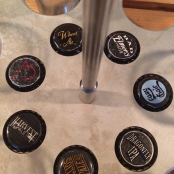 Upland Brewing Co. Bloomington Brewpub - Really cool way they serve their flights, labeled by the bottle caps! - Brewpubs Near Me - Bloomington, Indiana