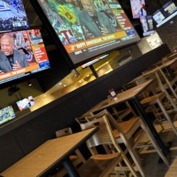 televisions and tables in a restaurant